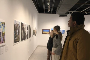 C of O students tour the photography exhibit at the Boger Art Gallery.